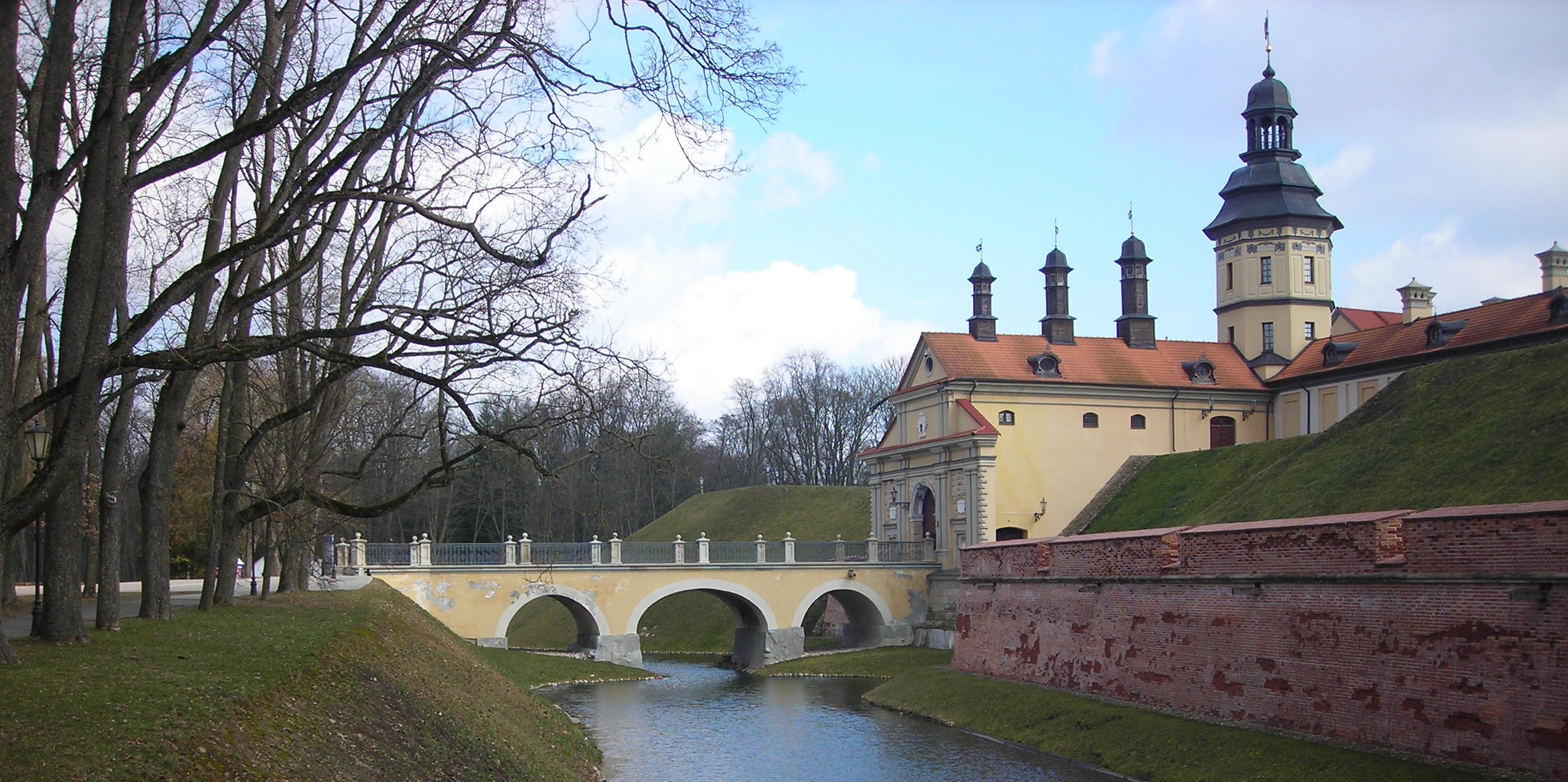 A castle in Belarus with a moat in front of it.